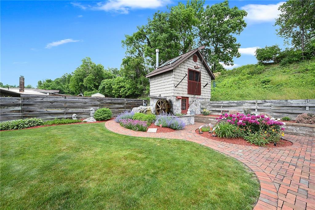 38 Manor Road Donora, PA 15033 - Photo 21 of 25 a view of a house with a big yard and potted plants