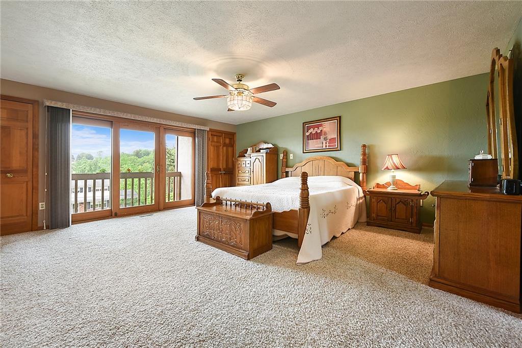 38 Manor Road Donora, PA 15033 - Photo 8 of 25 a spacious bedroom with a bed and a flat tv screen on dresser