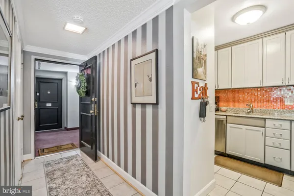 a view of a kitchen with wooden floor and cabinets