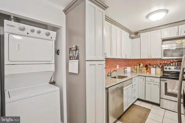 a kitchen with stainless steel appliances a refrigerator sink and stove