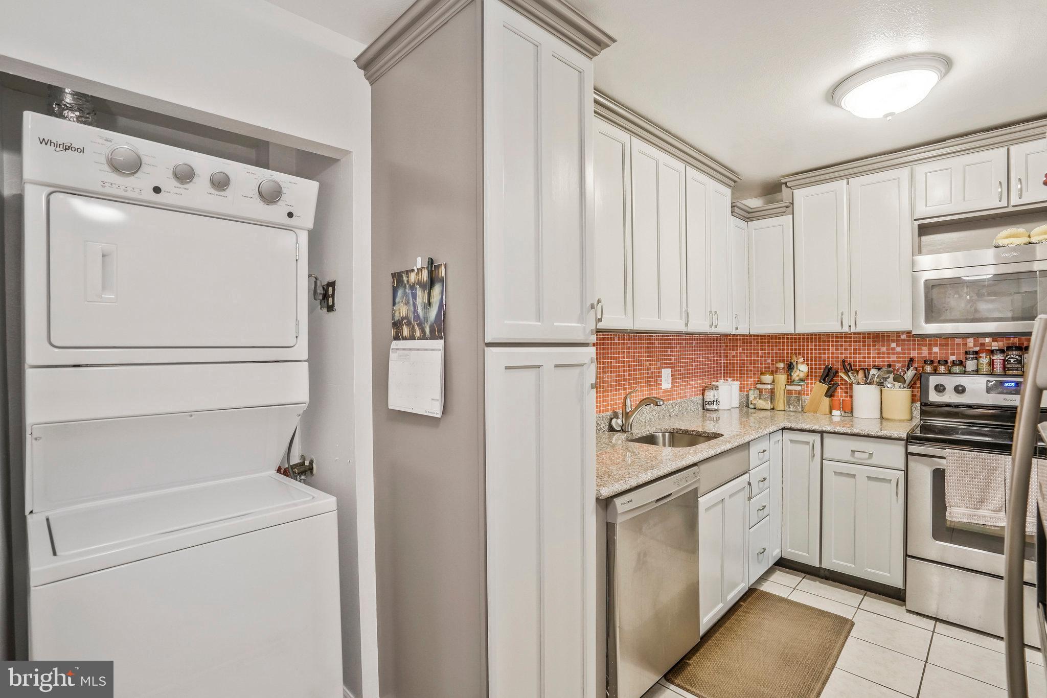 6101 Edsall Road, Unit 302 Alexandria, VA 22304 - Photo 16 of 59 a kitchen with white cabinets and white appliances