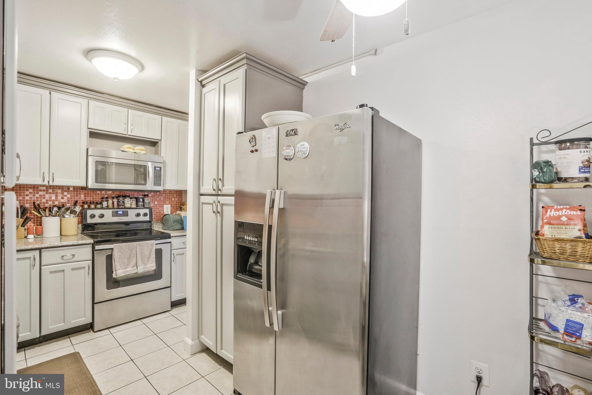 6101 Edsall Road, Unit 302 Alexandria, VA 22304 - Photo 17 of 59 a kitchen with stainless steel appliances a refrigerator sink and stove