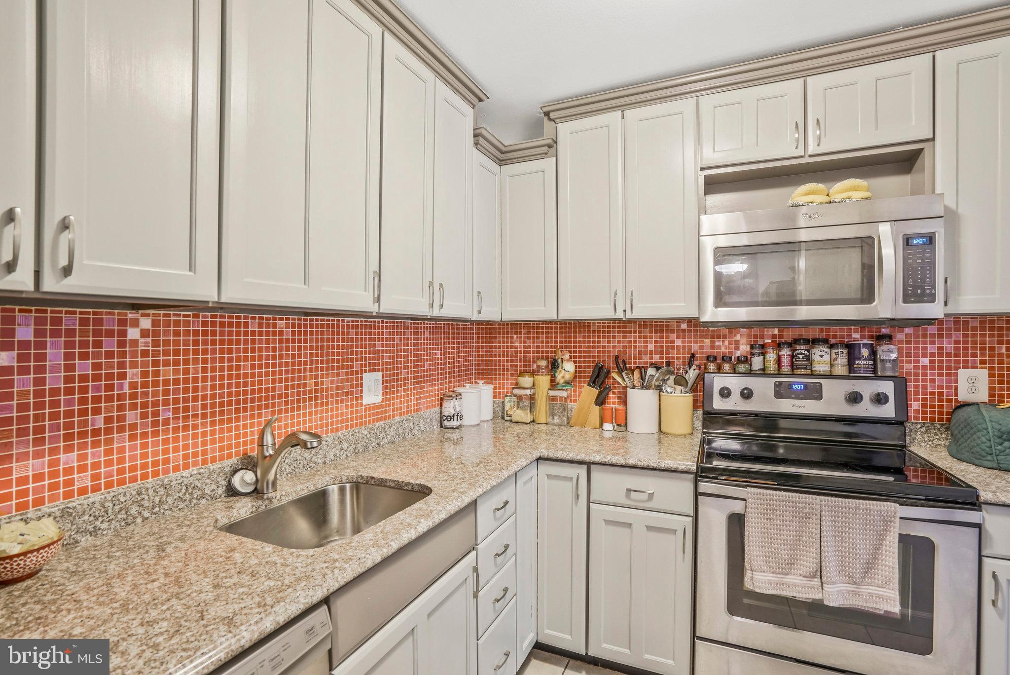 6101 Edsall Road, Unit 302 Alexandria, VA 22304 - Photo 18 of 59 a kitchen with stainless steel appliances granite countertop a sink stove and cabinets