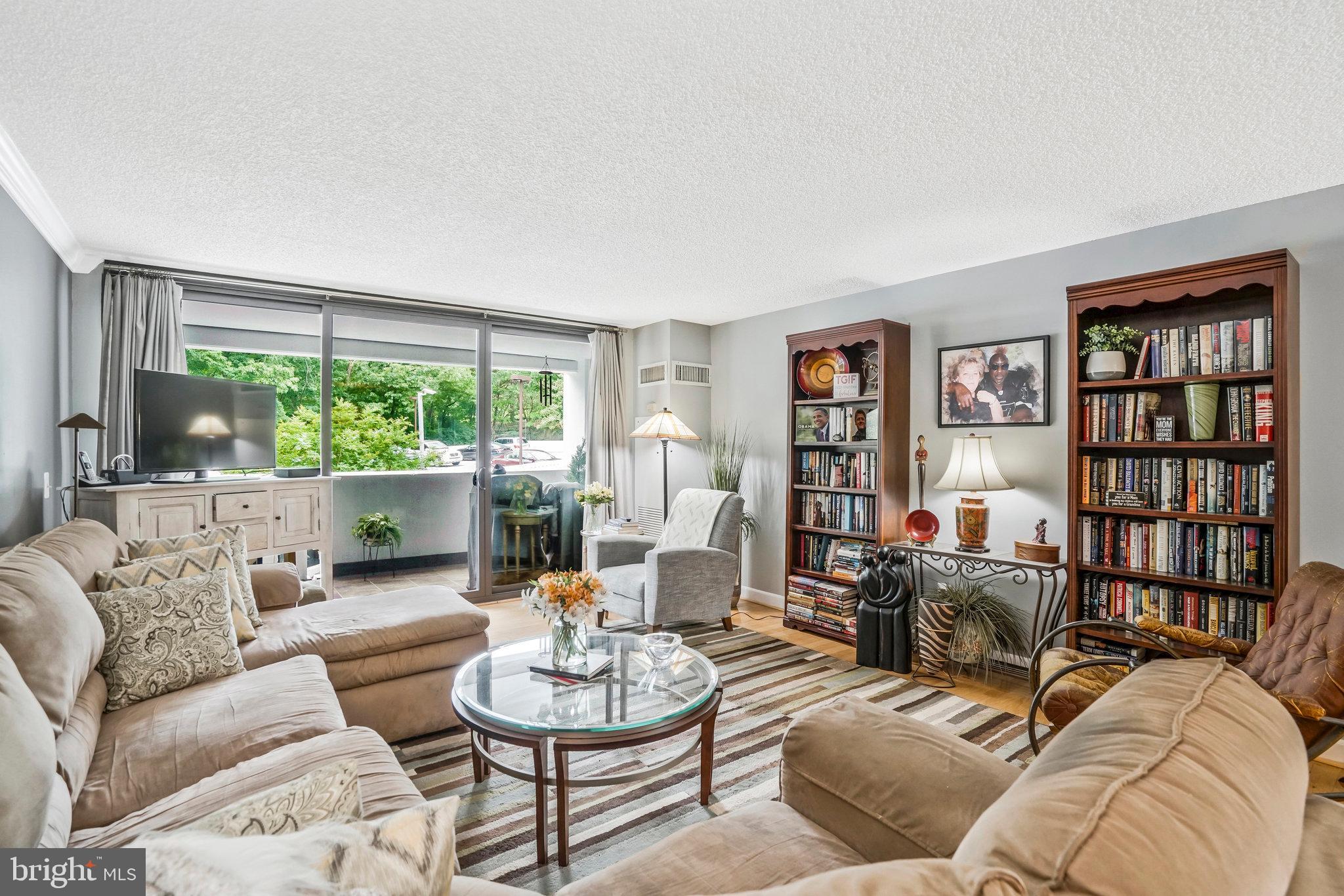 6101 Edsall Road, Unit 302 Alexandria, VA 22304 - Photo 2 of 59 a living room with furniture and a large window