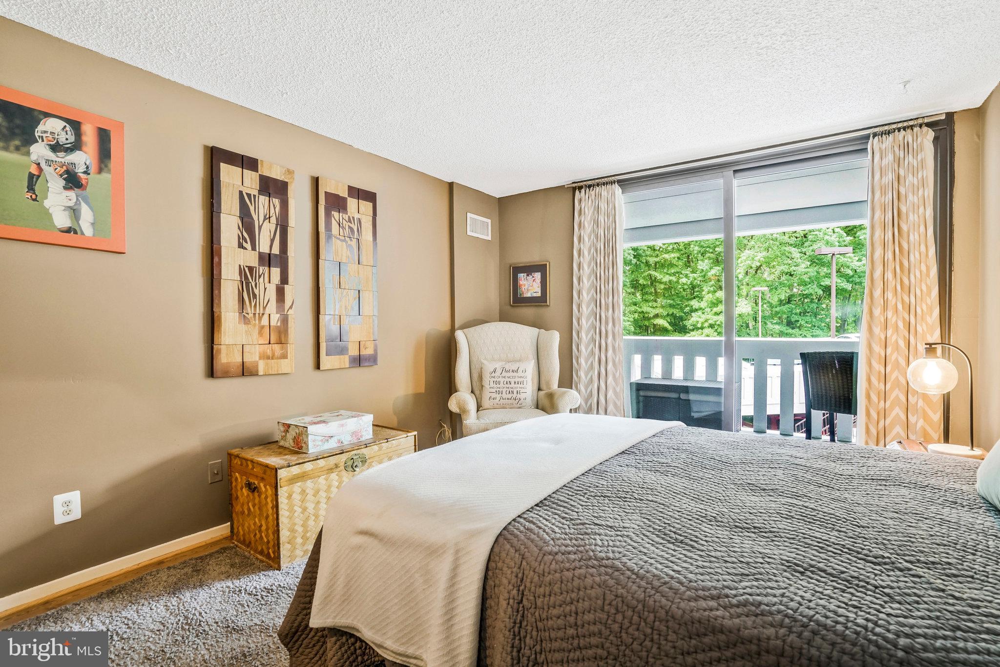 6101 Edsall Road, Unit 302 Alexandria, VA 22304 - Photo 30 of 59 a bedroom with a bed and a large window