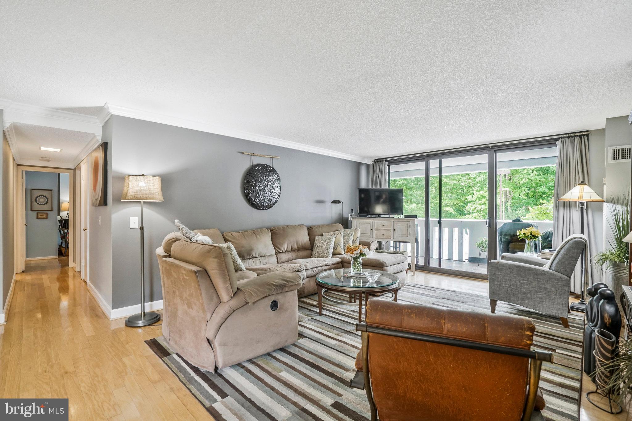 6101 Edsall Road, Unit 302 Alexandria, VA 22304 - Photo 3 of 59 a living room with furniture and a large window