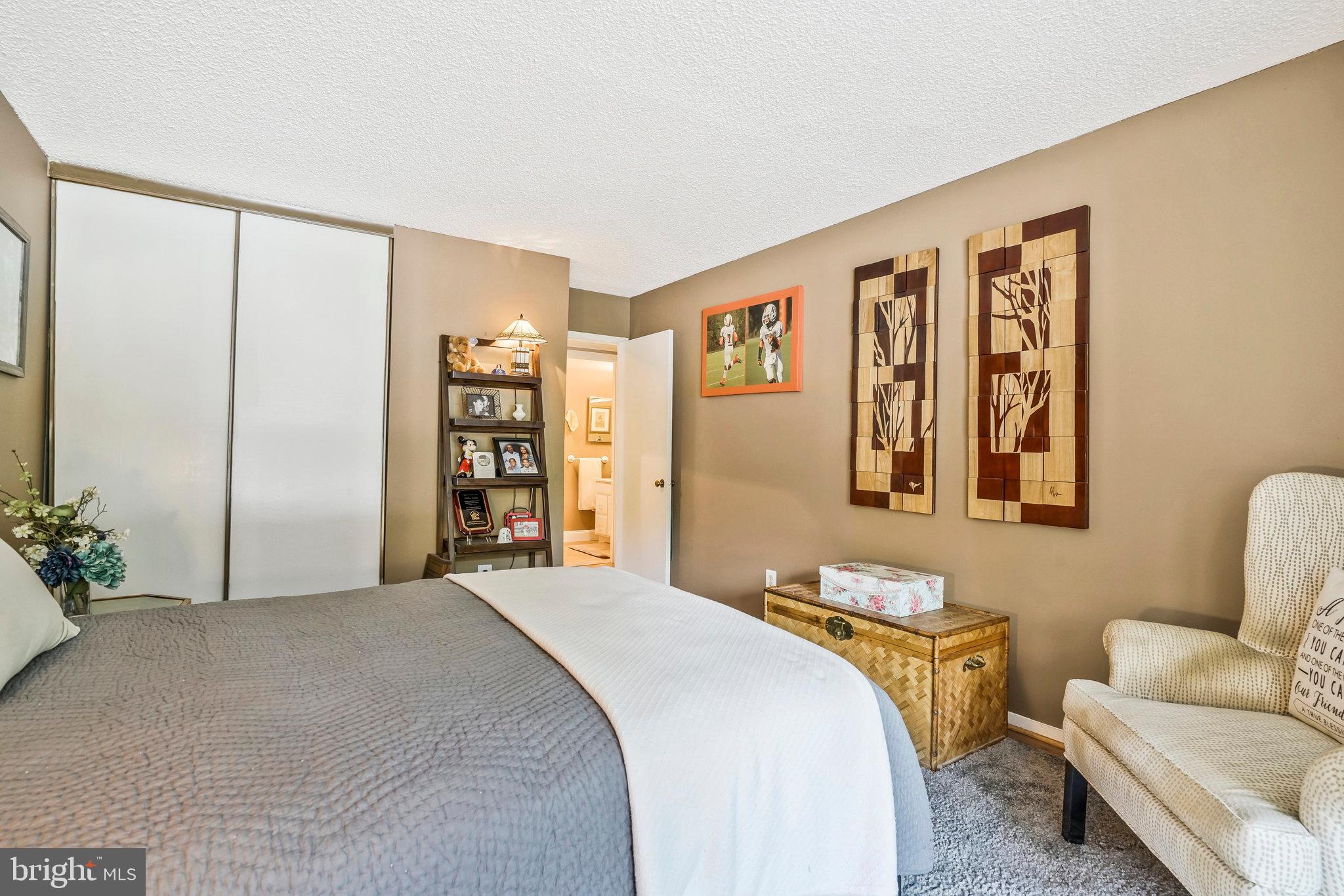 6101 Edsall Road, Unit 302 Alexandria, VA 22304 - Photo 31 of 59 a spacious bedroom with a bed and a couch