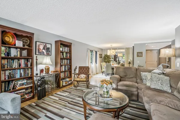 a living room with furniture and a book shelf