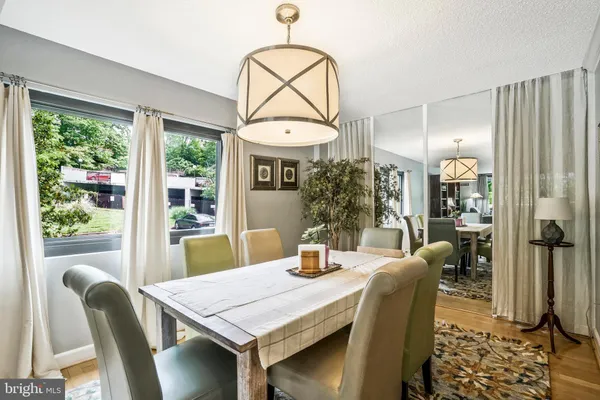 a view of a dining room with furniture window and wooden floor