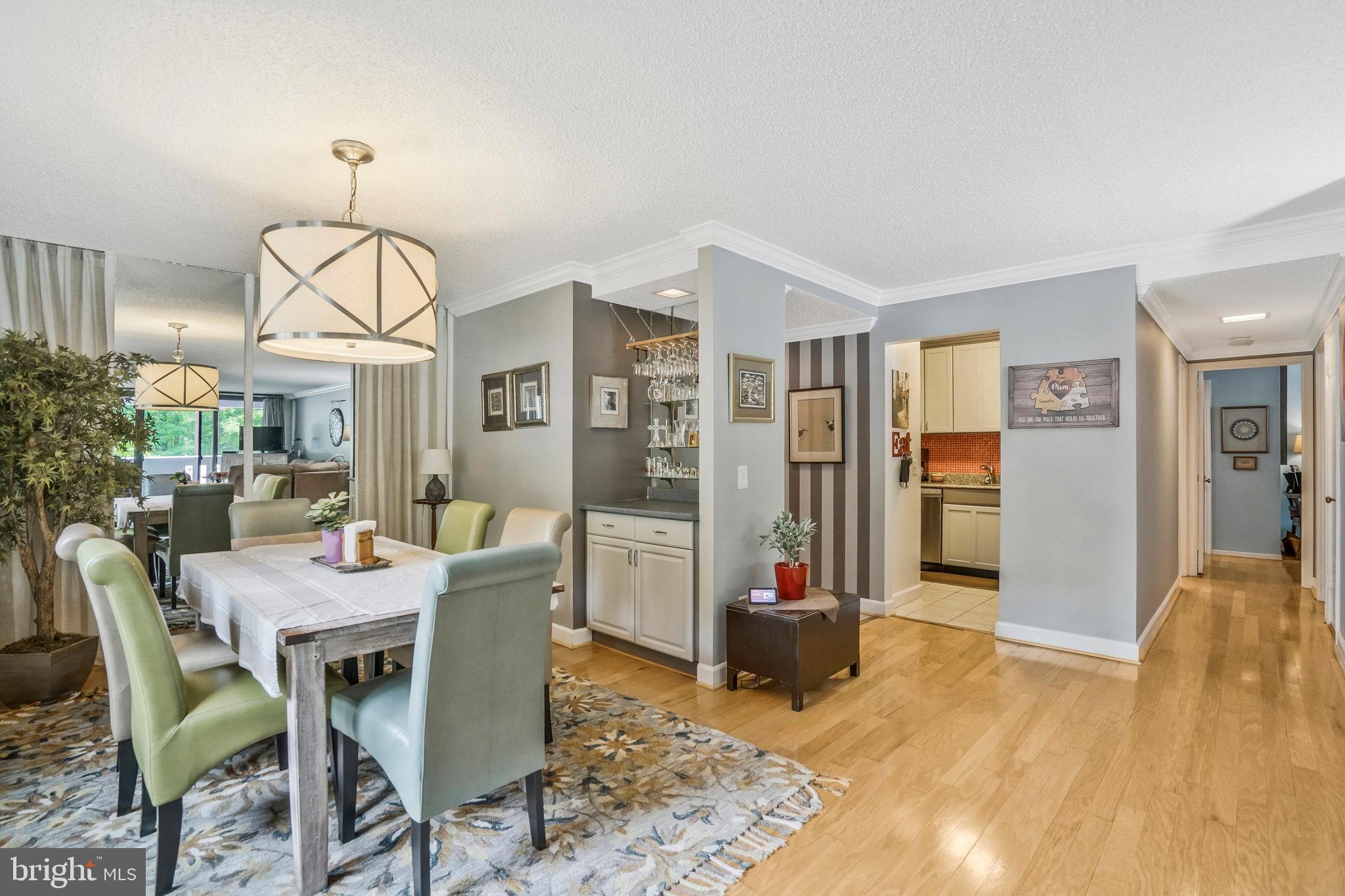 6101 Edsall Road, Unit 302 Alexandria, VA 22304 - Photo 10 of 59 a view of a dining room with furniture window and wooden floor