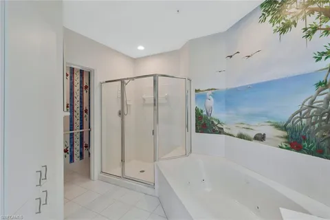 a bedroom with two beds and a chandelier