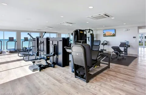 a room with gym equipment and a flat screen tv