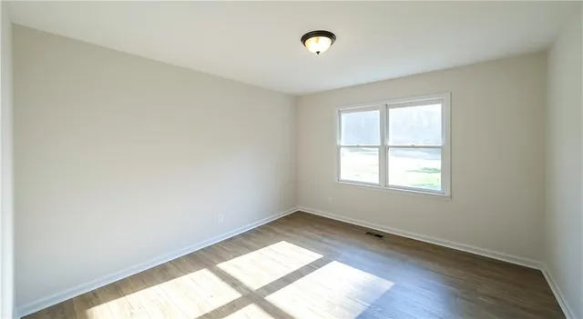 a view of a room with wooden floor and brick walls