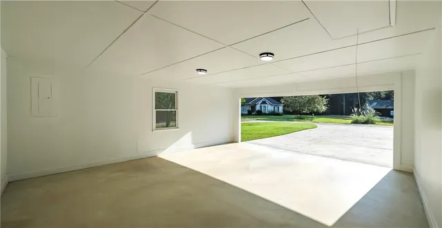 a view of a room with wooden floor mirror and windows