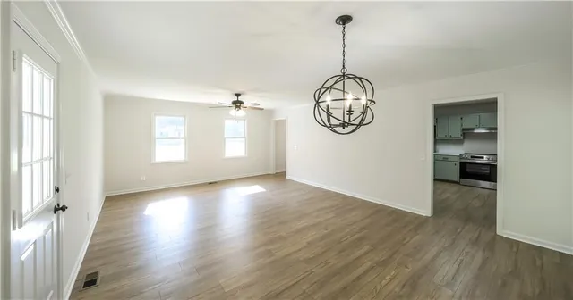 a kitchen with granite countertop a sink stove and refrigerator