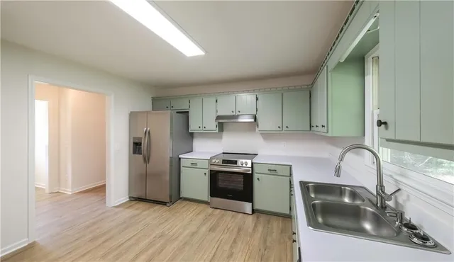 a view of a room with wooden floor