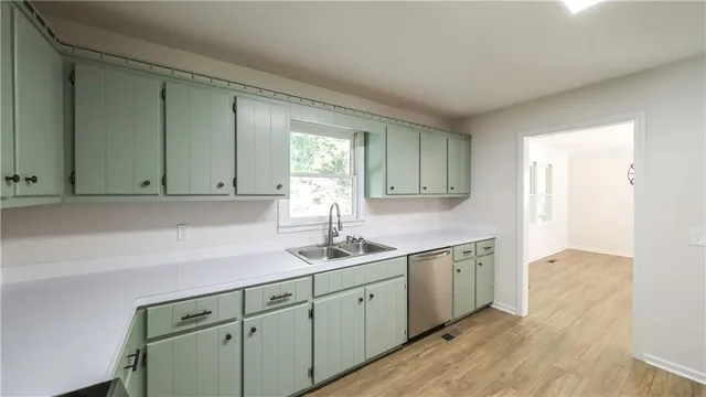 a view of a livingroom with wooden floor and a window