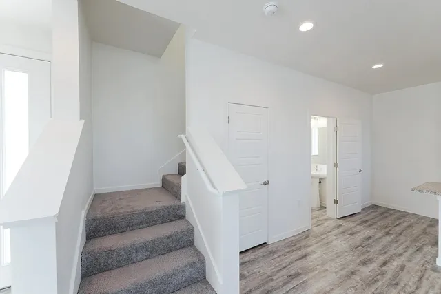 a view of entryway and hall with wooden floor