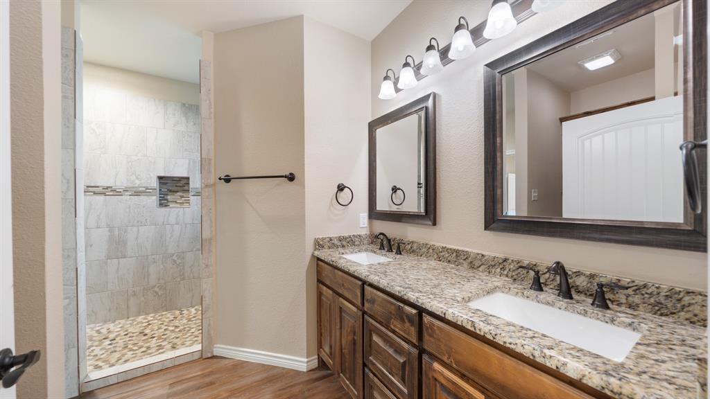 1401 Ridgebriar Drive Kaufman, TX 75142 - Photo 12 of 26 Primary bathroom featuring granite countertops and walk in shower