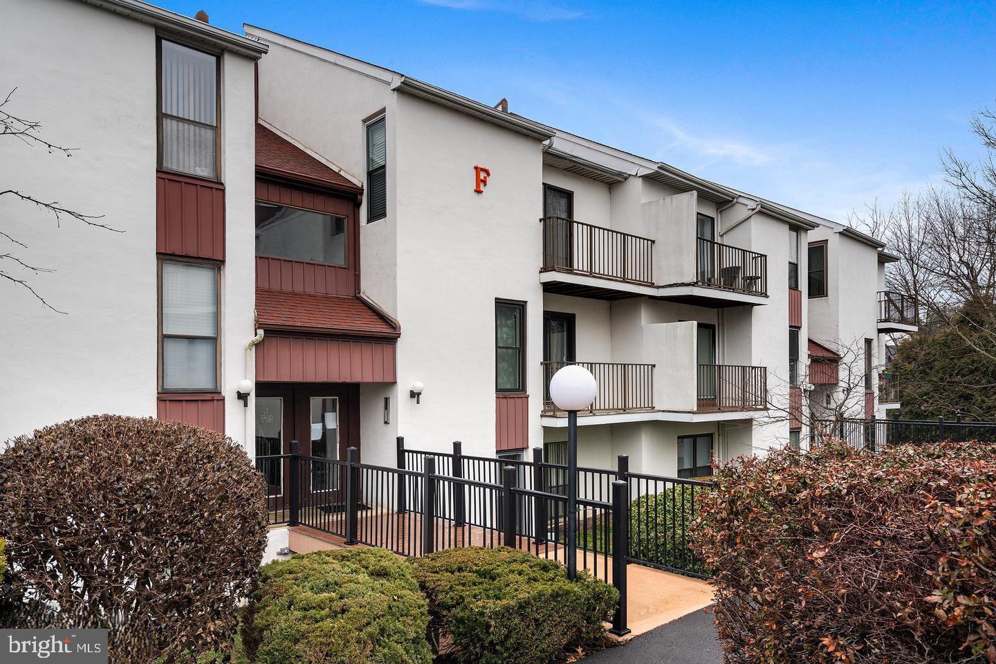 a front view of a house with wooden fence