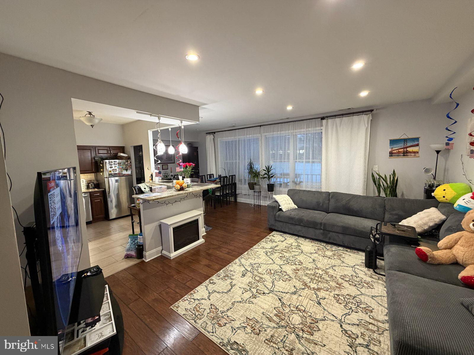 301-00 Byberry Road, Unit F4 Philadelphia, PA 19116 - Photo 4 of 14 a living room with fireplace furniture and a flat screen tv