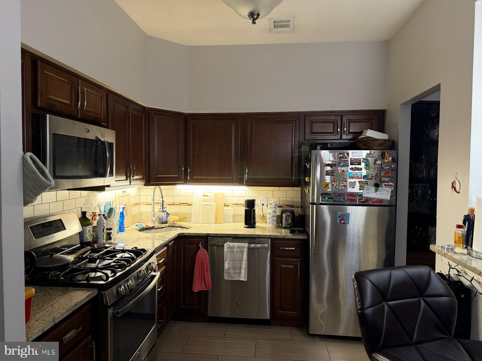 301-00 Byberry Road, Unit F4 Philadelphia, PA 19116 - Photo 6 of 14 a kitchen with stainless steel appliances a stove a sink and a refrigerator