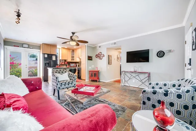 a living room with furniture and a flat screen tv