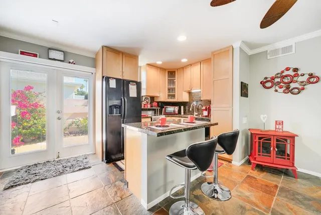 a kitchen with stainless steel appliances granite countertop a stove a sink and a refrigerator