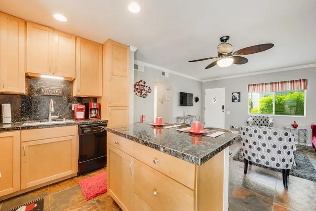 a kitchen with stainless steel appliances granite countertop a stove and a sink