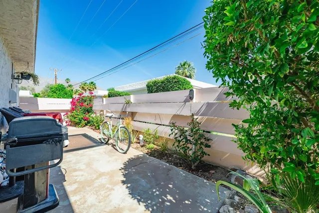 a spacious bedroom with a bed and a chandelier