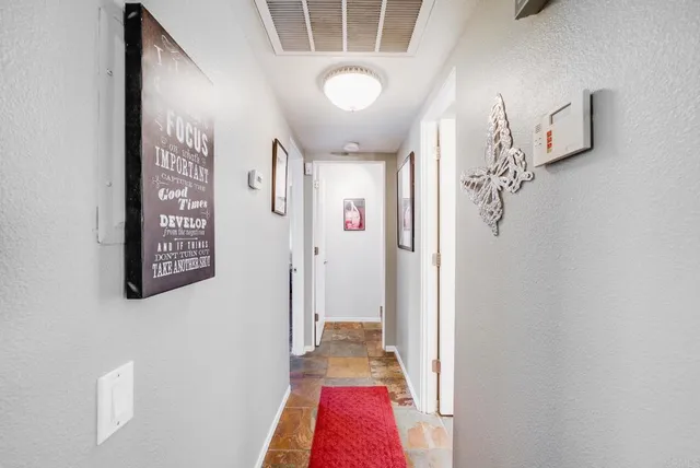 a spacious bedroom with a bed and a flat screen tv