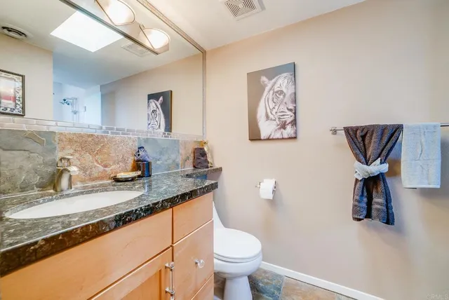 a vase of flowers sitting on a table with a mirror