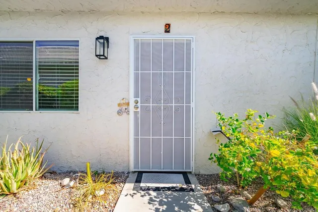 a view of a patio with table and chairs and potted plants