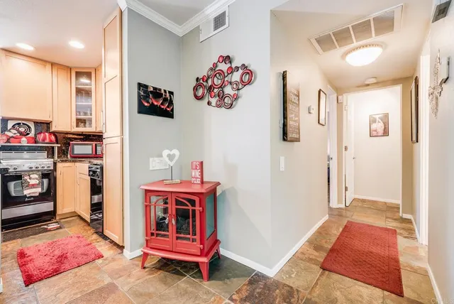 a open kitchen with stainless steel appliances granite countertop a refrigerator and a stove top oven