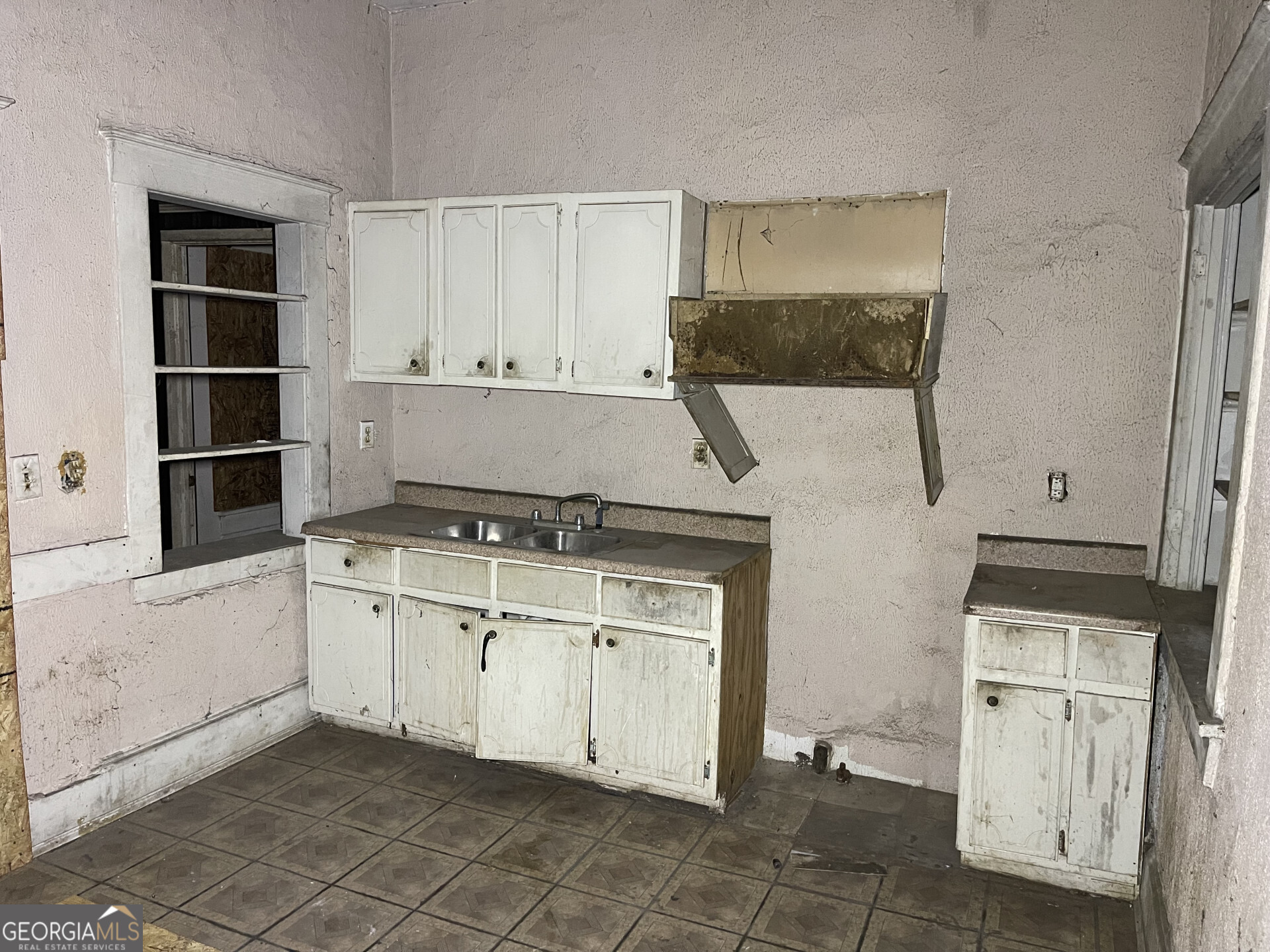 1851 Coleman Avenue Macon, GA 31201 - Photo 21 of 23 a kitchen with a stove and white cabinets