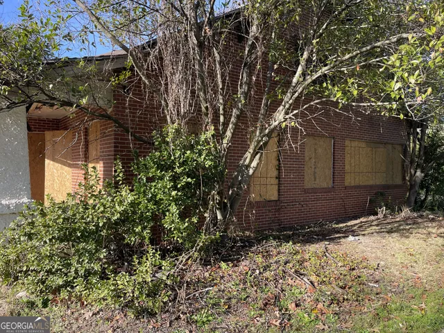 a view of a house with brick walls