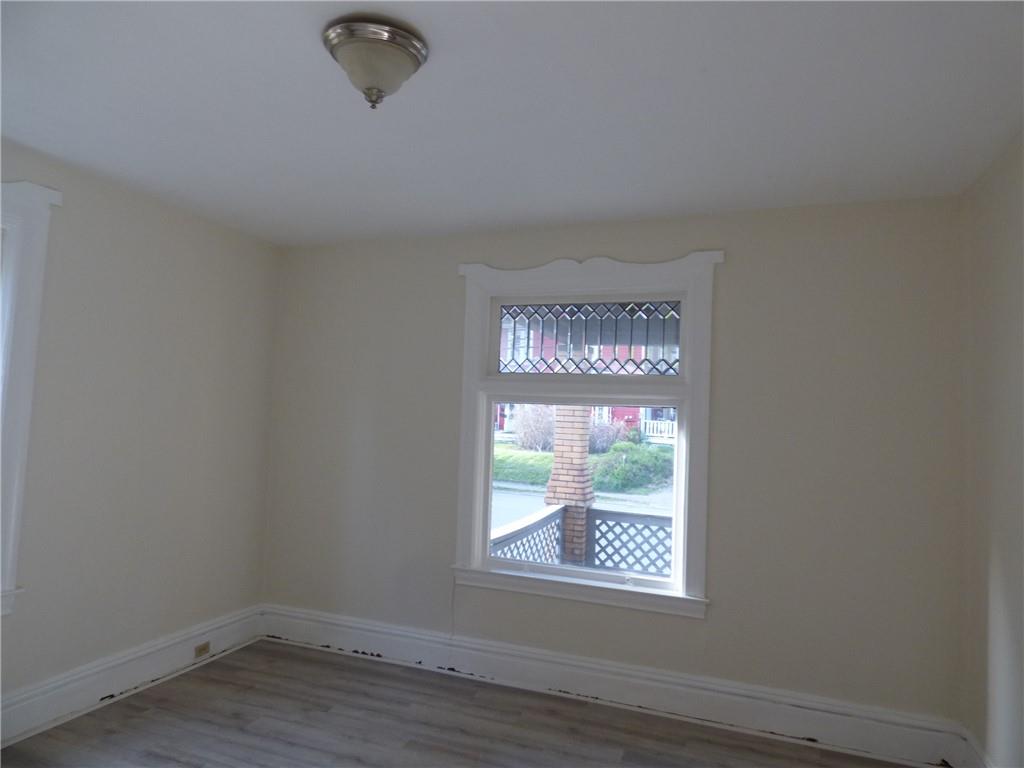 183 West Prospect Avenue, Unit 1B Pittsburgh, PA 15205 - Photo 3 of 17 an empty room with wooden floor and windows