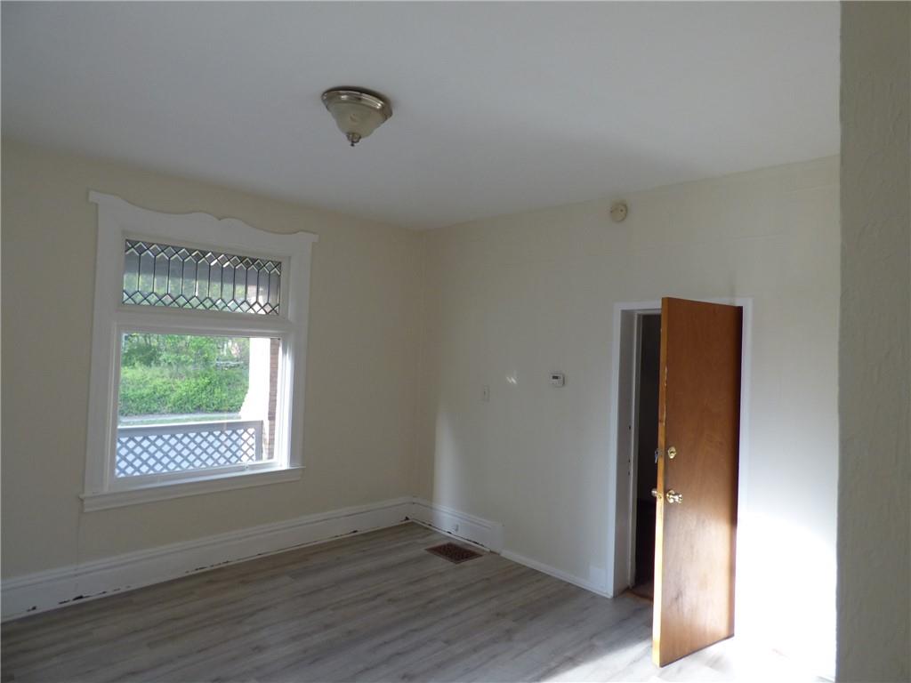 183 West Prospect Avenue, Unit 1B Pittsburgh, PA 15205 - Photo 4 of 17 a view of an empty room with wooden floor and a window
