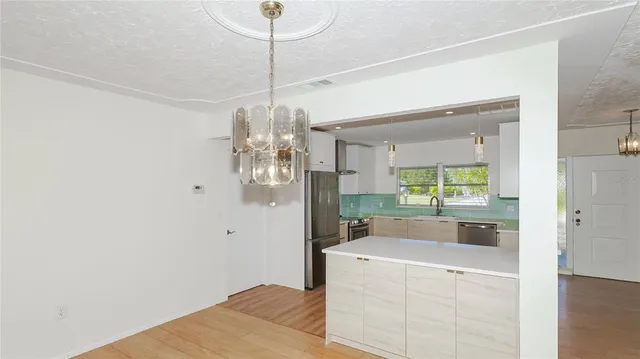 a view of a kitchen from the hallway