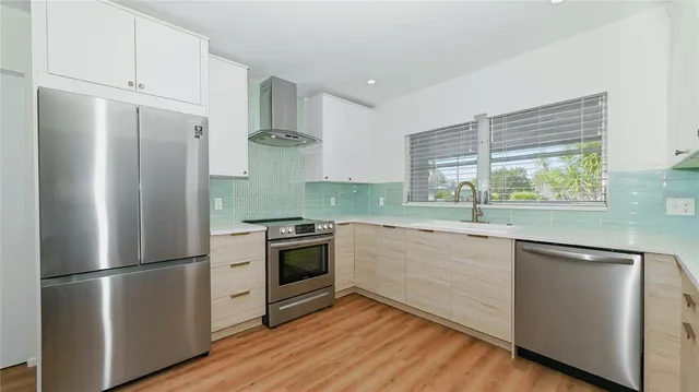 a kitchen with stainless steel appliances a refrigerator stove and sink