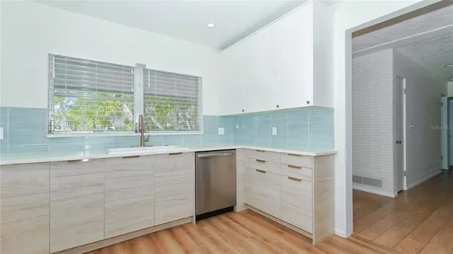 a view of a kitchen counter space with wooden floor