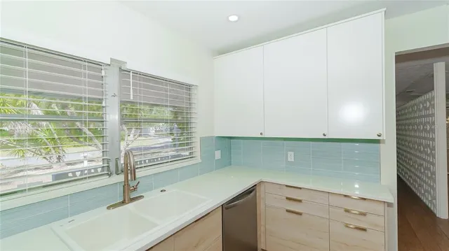 a kitchen with a sink and a large window