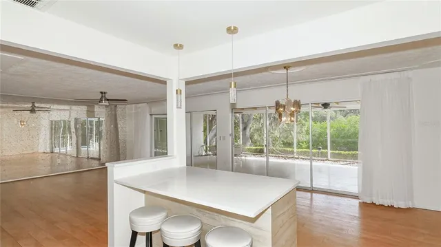a view of a kitchen with a table and a large window