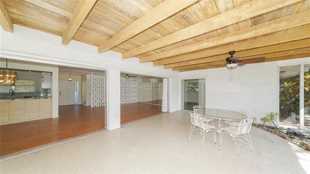 a view of a patio with a table and chairs