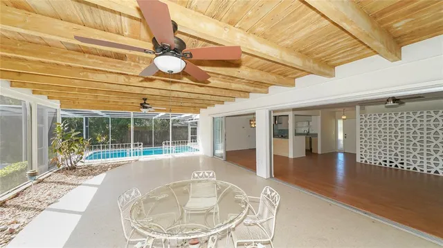 a view of a patio with a table and chairs
