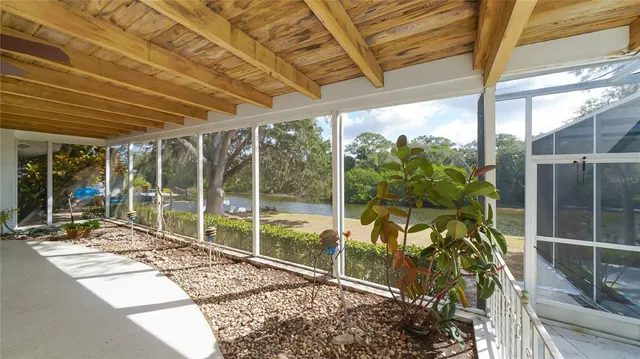 a view of a porch with furniture and garden
