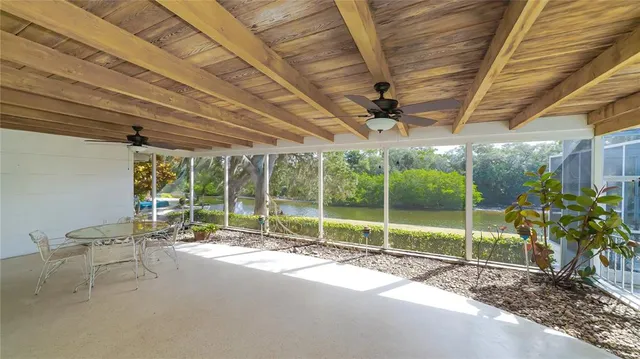a house with a bed and a wooden roof
