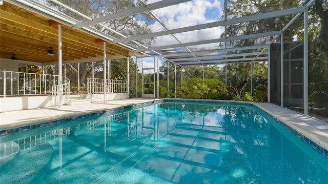 a swimming pool with yard in front of it