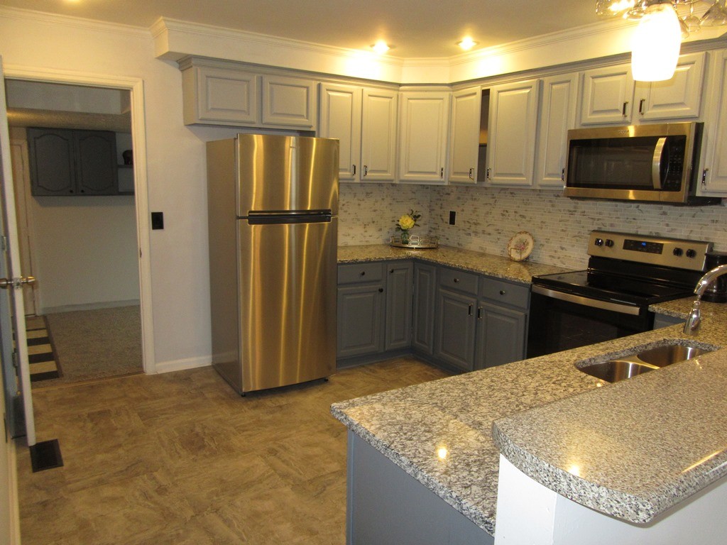 569 Lafayette Road Clarksville, TN 37042 - Photo 6 of 25 a kitchen with stainless steel appliances granite countertop a refrigerator a stove and a sink