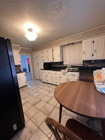 a kitchen with stainless steel appliances wooden cabinets and a stove top oven
